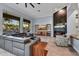 Modern living room featuring hardwood floors, a sleek fireplace, and large windows with scenic views at 10694 E Redfield Rd, Scottsdale, AZ 85255