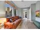 Inviting living room with large leather couch, fireplace views, and hardwood floors at 10694 E Redfield Rd, Scottsdale, AZ 85255