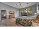 Spacious main bedroom with hardwood floors, ceiling fan, and outdoor views through multiple windows at 10694 E Redfield Rd, Scottsdale, AZ 85255