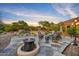 Relaxing backyard patio with fire pit, lounge chairs, and pool view at 10694 E Redfield Rd, Scottsdale, AZ 85255