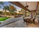 Outdoor patio featuring built-in grill, dining area, and landscaped backyard at 10694 E Redfield Rd, Scottsdale, AZ 85255