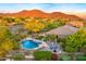 Enjoy this luxurious backyard pool and spa, complete with lush landscaping and stunning desert mountain views at 10694 E Redfield Rd, Scottsdale, AZ 85255