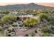 Expansive aerial view of the desert home showcasing the pool, landscaped yard, and mountain backdrop at 10822 E Prospect Point Dr, Scottsdale, AZ 85262