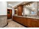 Bathroom features wood cabinets with a granite countertop and large mirrors at 10822 E Prospect Point Dr, Scottsdale, AZ 85262