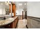 Bathroom features a large vanity with dual sinks, granite countertop, and travertine flooring at 10822 E Prospect Point Dr, Scottsdale, AZ 85262