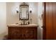 Bathroom features a carved wood vanity, unique mirror, and sconce lighting at 10822 E Prospect Point Dr, Scottsdale, AZ 85262