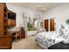 Bright bedroom with desk, ceiling fan, large window, and neutral carpet at 10822 E Prospect Point Dr, Scottsdale, AZ 85262