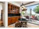 Dining area with glass doors leading to outdoor patio and featuring built-in cabinetry at 10822 E Prospect Point Dr, Scottsdale, AZ 85262