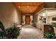 Inviting front entrance with wood-paneled ceiling, desert plants, and a view into the living area at 10822 E Prospect Point Dr, Scottsdale, AZ 85262