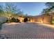 Beautiful home featuring a spacious front driveway, three-car garage, and desert landscaping, creating a welcoming ambiance at 10822 E Prospect Point Dr, Scottsdale, AZ 85262