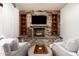 Comfortable living space with stone fireplace, built-in shelves, and neutral color palette at 10822 E Prospect Point Dr, Scottsdale, AZ 85262