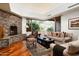 Cozy living room features a stone fireplace, wood floors, and comfortable seating at 10822 E Prospect Point Dr, Scottsdale, AZ 85262