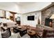 Inviting living room featuring stone fireplace, wood floors, and comfortable seating arrangement at 10822 E Prospect Point Dr, Scottsdale, AZ 85262