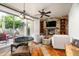 Cozy living room with stone fireplace, built-in shelves, and an abundance of natural light at 10822 E Prospect Point Dr, Scottsdale, AZ 85262