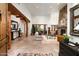 Grand living room boasts stone floors, a fireplace, and natural light, offering a seamless blend of rustic charm and modern comfort at 10822 E Prospect Point Dr, Scottsdale, AZ 85262
