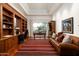 Spacious office features custom bookshelves, wood flooring, and a large window at 10822 E Prospect Point Dr, Scottsdale, AZ 85262
