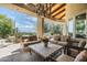 Inviting covered patio with comfortable seating and a stylish chandelier, perfect for entertaining guests at 10822 E Prospect Point Dr, Scottsdale, AZ 85262