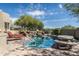 Sparkling pool area showcasing rock features, a stone patio, and desert views at 10822 E Prospect Point Dr, Scottsdale, AZ 85262