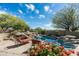 Sparkling pool area with desert landscaping, a hot tub, and comfortable seating, perfect for relaxation at 10822 E Prospect Point Dr, Scottsdale, AZ 85262