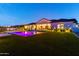 Beautiful backyard with a sparkling pool, lush artificial turf, and a covered patio perfect for outdoor relaxation at 10918 W Dove Roost Rd, Queen Creek, AZ 85144