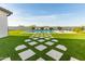 Lush backyard features a sparkling pool, artificial turf, and inviting lounge chairs for sun-soaked relaxation at 10918 W Dove Roost Rd, Queen Creek, AZ 85144