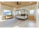 Bright and airy bedroom with natural light, a four-poster bed, and stylish furnishings at 10918 W Dove Roost Rd, Queen Creek, AZ 85144