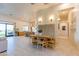 Bright open-concept dining area with tile flooring and modern furnishings at 10918 W Dove Roost Rd, Queen Creek, AZ 85144