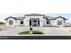 Modern white home with a black tile roof, manicured yard and decorative front door at 10918 W Dove Roost Rd, Queen Creek, AZ 85144