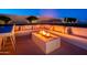 Charming outdoor firepit area with cozy seating, perfect for relaxing evenings with friends and Gathering at 10918 W Dove Roost Rd, Queen Creek, AZ 85144