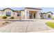 Elegant home exterior with desert landscaping, a circular driveway, and a grand entrance, showcasing curb appeal at 10918 W Dove Roost Rd, Queen Creek, AZ 85144