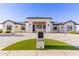 Beautiful home exterior featuring clean lines, desert landscaping, and a manicured lawn, enhancing curb appeal at 10918 W Dove Roost Rd, Queen Creek, AZ 85144