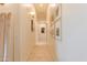 Hallway with modern light fixtures and a gallery wall showcasing Gathering photos at 10918 W Dove Roost Rd, Queen Creek, AZ 85144