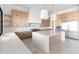 Bright kitchen boasts an island, stainless steel appliances, tile backsplash, and modern cabinets at 10918 W Dove Roost Rd, Queen Creek, AZ 85144