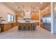 Spacious kitchen with a large island, modern appliances, and stylish pendant lighting at 10918 W Dove Roost Rd, Queen Creek, AZ 85144