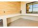 Outdoor kitchen space with wood paneling, countertop, and window overlooking a green yard at 10918 W Dove Roost Rd, Queen Creek, AZ 85144