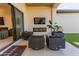 Relaxing outdoor patio with sleek furniture, a modern fireplace, and a mounted television for entertainment at 10918 W Dove Roost Rd, Queen Creek, AZ 85144