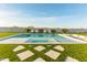 Beautiful backyard swimming pool and patio area with multiple lounge chairs and comfortable seating at 10918 W Dove Roost Rd, Queen Creek, AZ 85144