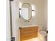 Stylish powder room with modern fixtures, a unique mirror, and a floating vanity at 10918 W Dove Roost Rd, Queen Creek, AZ 85144