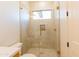 Modern bathroom features a sleek glass-enclosed shower with contemporary fixtures and tile at 10918 W Dove Roost Rd, Queen Creek, AZ 85144