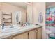 Well-lit bathroom featuring dual sinks, plenty of counter space, and updated fixtures at 11596 W Sierra Dawn Blvd # 271, Surprise, AZ 85378