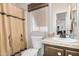 Compact bathroom with a shower curtain and a vanity with a decorative mirror at 11596 W Sierra Dawn Blvd # 271, Surprise, AZ 85378