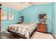 Brightly lit bedroom with cool-toned walls, wood floors and comfy quilt bedding at 11596 W Sierra Dawn Blvd # 271, Surprise, AZ 85378