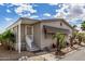 Corner lot featuring a white stairway leading to the front door and mature landscaping along the side of the home at 11596 W Sierra Dawn Blvd # 271, Surprise, AZ 85378