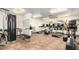 Gym area with multiple treadmills, weight-lifting equipment and wall mirrors at 11596 W Sierra Dawn Blvd # 271, Surprise, AZ 85378