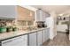 Bright kitchen features grey cabinetry, granite countertops, stainless steel sink, and modern appliances at 11596 W Sierra Dawn Blvd # 271, Surprise, AZ 85378