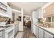 Well-lit kitchen features updated countertops, white appliances, and stylish tile backsplash and wood look flooring at 11596 W Sierra Dawn Blvd # 271, Surprise, AZ 85378