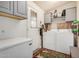 Functional laundry area with washer, dryer, freezer, gray cabinets, and an exterior door at 11596 W Sierra Dawn Blvd # 271, Surprise, AZ 85378