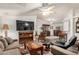 Well-lit living room featuring plush furniture, a large TV, and an open design, seamlessly connecting to the dining area at 11596 W Sierra Dawn Blvd # 271, Surprise, AZ 85378