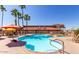 Community pool area with lounge chairs and palm trees at 11596 W Sierra Dawn Blvd # 271, Surprise, AZ 85378