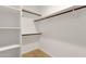 Walk-in closet with shelving and wooden racks offering ample storage space at 11775 E Becker Ln, Scottsdale, AZ 85259